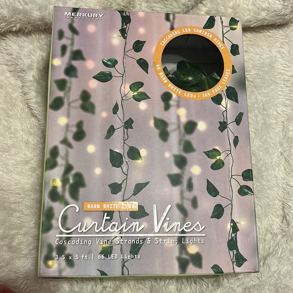 Curtain vines, consistent of cascading, vine, strands in string lights.